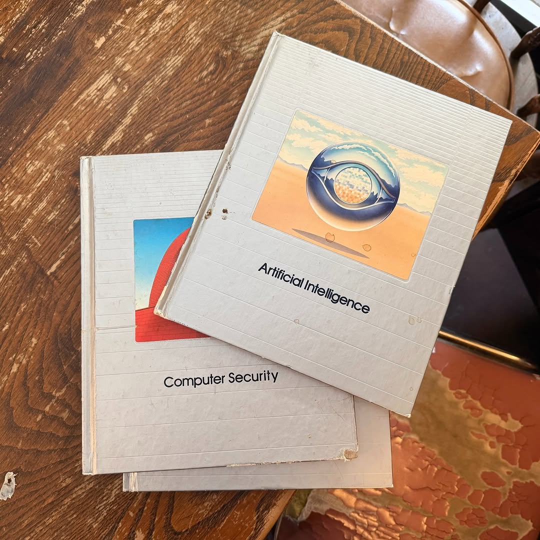 The covers of two books, with the titles Artificial Intelligence and Computer Security