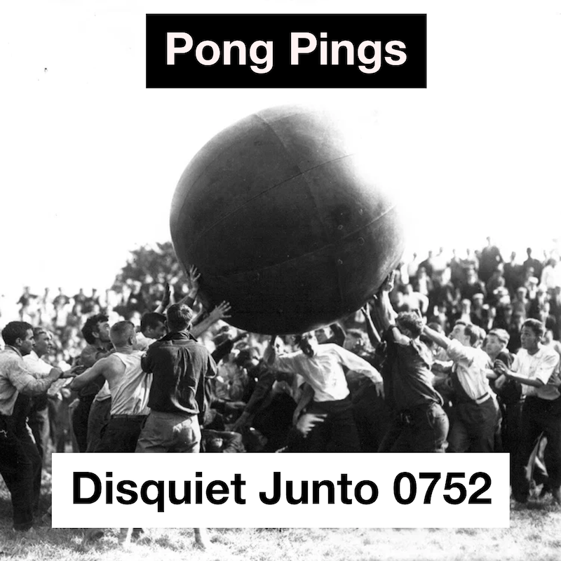 A crowd of people holding a large ball aloft, plus the name and number of the project